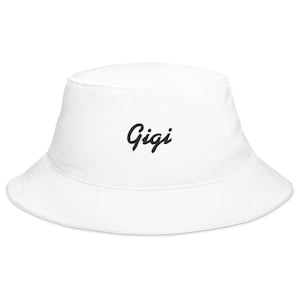 May include: White bucket hat with the word "Gigi" embroidered in black cursive lettering.