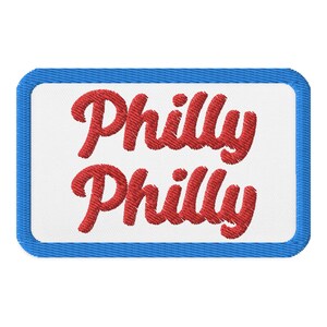 May include: A white patch with a blue border, featuring the text "Philly Philly" in red embroidered lettering.