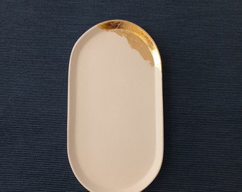 White concrete tray, dotted with gold