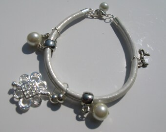 White bracelet with pearls.
