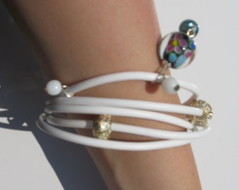 White bracelet with a big colourful ball