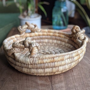 round wicker jute basket with three knotted handles | eclectic bohemian rustic coffeetable centerpiece