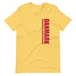 May include: Yellow short-sleeved t-shirt with the word "DANMARK" printed vertically in red on the right side of the shirt.