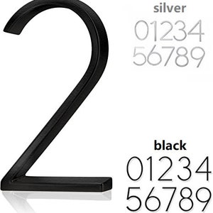 May include: A black metal number 2, with a modern font, is displayed prominently. The image also shows a set of silver and black numbers 0-9, in a similar font. The word "silver" and "black" are above the numbers.
