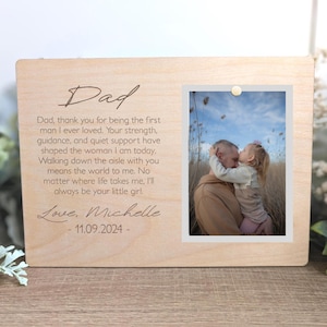 May include: A light-colored wooden picture frame with a photograph of a man and a child. The frame has the word "Dad" engraved at the top, along with a heartfelt message and the date 11.09.2024.