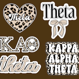 May include: A collection of stickers with sorority-themed designs. The stickers feature the word "Theta" in various fonts and styles, including a heart-shaped design with a leopard print pattern. Other stickers include "KAO" and "Kappa Alpha Theta".