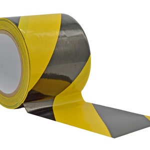 May include: A roll of yellow and black striped caution tape. The tape is rolled up and has a black and yellow striped pattern.