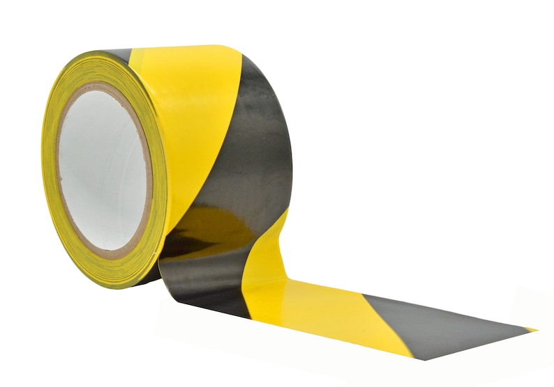 May include: A roll of yellow and black striped caution tape. The tape is partially unrolled, showing the black and yellow stripes.