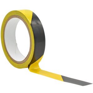 May include: A roll of yellow and black hazard tape. The tape is partially unrolled, showing the black and yellow stripes.