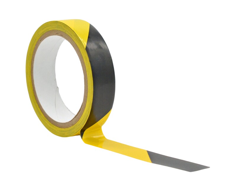 May include: A roll of yellow and black hazard tape. The tape is partially unrolled, showing the black and yellow stripes.