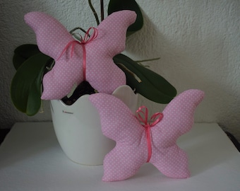 2 butterflies sewn from fabric, pink with dots