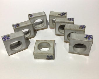 A set of 8 ceramic pottery napkin rings
