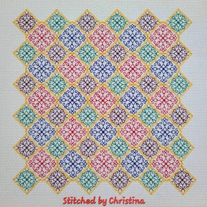 May include: A colorful cross-stitch pattern with a repeating geometric design. The pattern features a variety of colors, including red, blue, green, yellow, and purple. The design is framed by a yellow border. The text "Stitched by Christina" is at the bottom of the image.