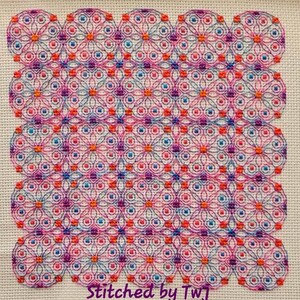 May include: A colorful cross-stitch pattern with a geometric design featuring circles, squares, and flowers in shades of pink, orange, blue, and purple. The text "Stitched by TwJ" is at the bottom of the image.