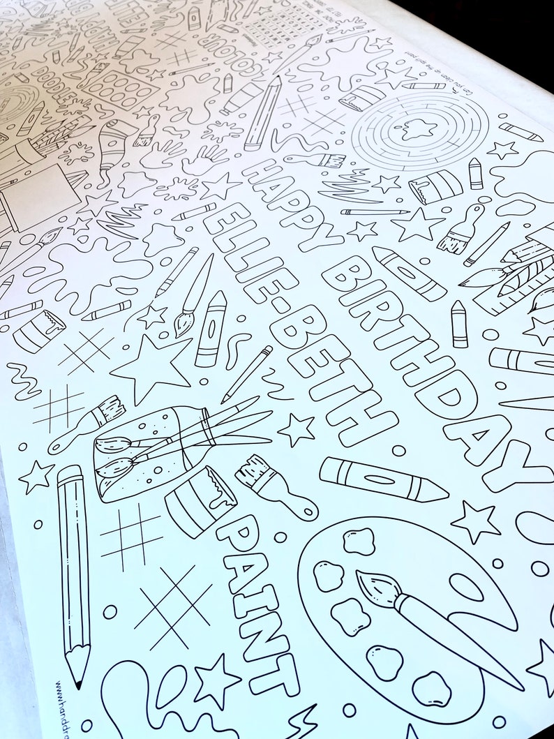 May include: A black and white coloring page with a birthday theme. The page features the words "Happy Birthday Ellie" and various art supplies, including paintbrushes, paint, pencils, and crayons.