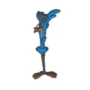 May include: An embroidered cartoon character patch of a roadrunner, in blue and brown, with its head tilted back and its legs spread out.
