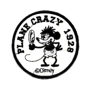 May include: Black and white embroidered patch featuring a cartoon mouse holding a mirror with the text "Plane Crazy 1928" and "©Disney" below the mouse.