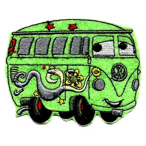 May include: Green Volkswagen van with a smiling face, psychedelic paint, and a flower design. The van has a gray snake design on the side and red stars on the roof.