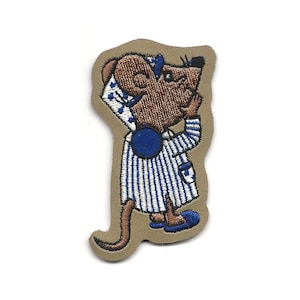 May include: Embroidered iron-on patch of a brown mouse wearing blue pajamas and a blue sleep cap. The mouse is standing on a tan background.