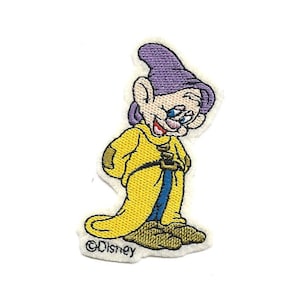 May include: An embroidered patch featuring a cartoon depiction of a dwarf from the Disney movie Snow White and the Seven Dwarfs. The dwarf is wearing a yellow coat, blue pants, and a purple hat. The patch has the Disney copyright symbol and the word "Disney" below the dwarf.