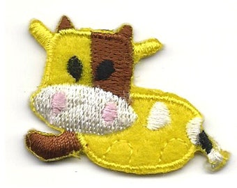 May include: An embroidered iron-on patch of a cartoon cow, yellow and brown with white spots and a pink nose.