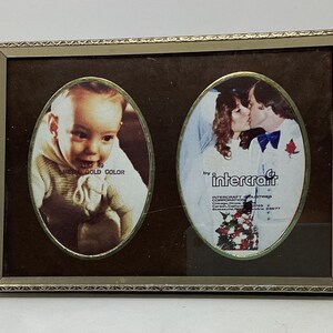 May include: A vintage double photo frame with oval openings. One side features a baby photo, the other a wedding photo. The frame is metal with a gold color and the text "METAL GOLD COLOR" is visible.