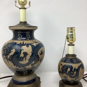 Vintage pair of beige and navy ceramic dragon lamps
