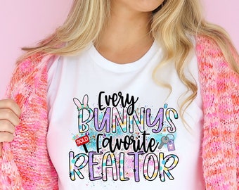 May include: White t-shirt with a colorful graphic that says "Every Bunny's Favorite Realtor" with a bunny, a house, and a sold sign.