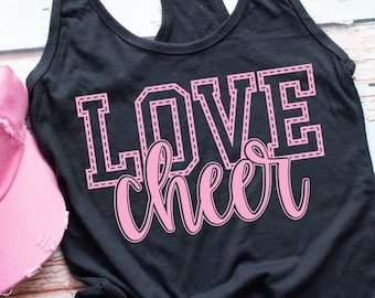 May include: Black tank top with the words "LOVE cheer" in pink lettering. The word "LOVE" is outlined with a pink stitched design.