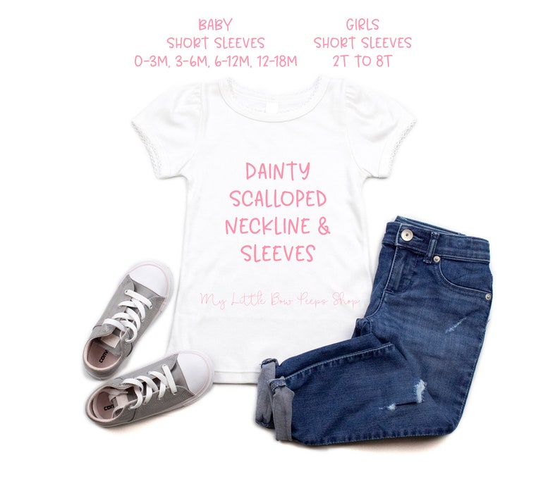 May include: A white baby and girls' short-sleeved shirt with a dainty scalloped neckline and sleeves, paired with blue jeans and gray sneakers. The shirt has text that reads "DAINTY SCALLOPED NECKLINE & SLEEVES". Sizes range from 0-3M to 8T.