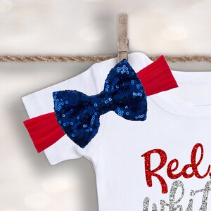 May include: White t-shirt with red glitter text that says "Red, White & Blue" and a blue sequin bow with a red headband.