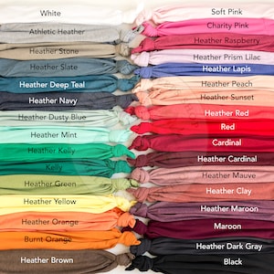 May include: A variety of t-shirt colors, including white, athletic heather, heather stone, heather slate, heather deep teal, heather navy, heather dusty blue, heather mint, heather kelly, kelly, heather green, heather yellow, heather orange, burnt orange, heather brown, soft pink, charity pink, heather raspberry, heather prism lilac, heather lapis, heather peach, heather sunset, heather red, red, cardinal, heather cardinal, heather mauve, heather clay, heather maroon, maroon, heather dark gray, and black.