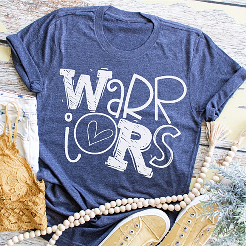 K&ouml;nnte beinhalten: Ein marineblaues T-Shirt mit dem Aufdruck "WARRIORS" in Wei&szlig;, wobei ein Herz in der Mitte des "O" platziert ist.