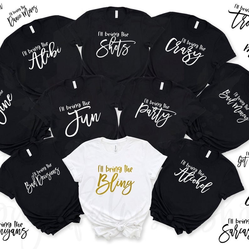 May include: Ten black t-shirts with white text and one white t-shirt with gold text. The shirts all have the phrase "I'll bring the" followed by a different word. The words are "Alibi", "Shots", "Crazy", "Fun", "Party", "Bad Decisions", "Bling", "Alcohol", "Soul Money", "Get", and "Sarcasm".