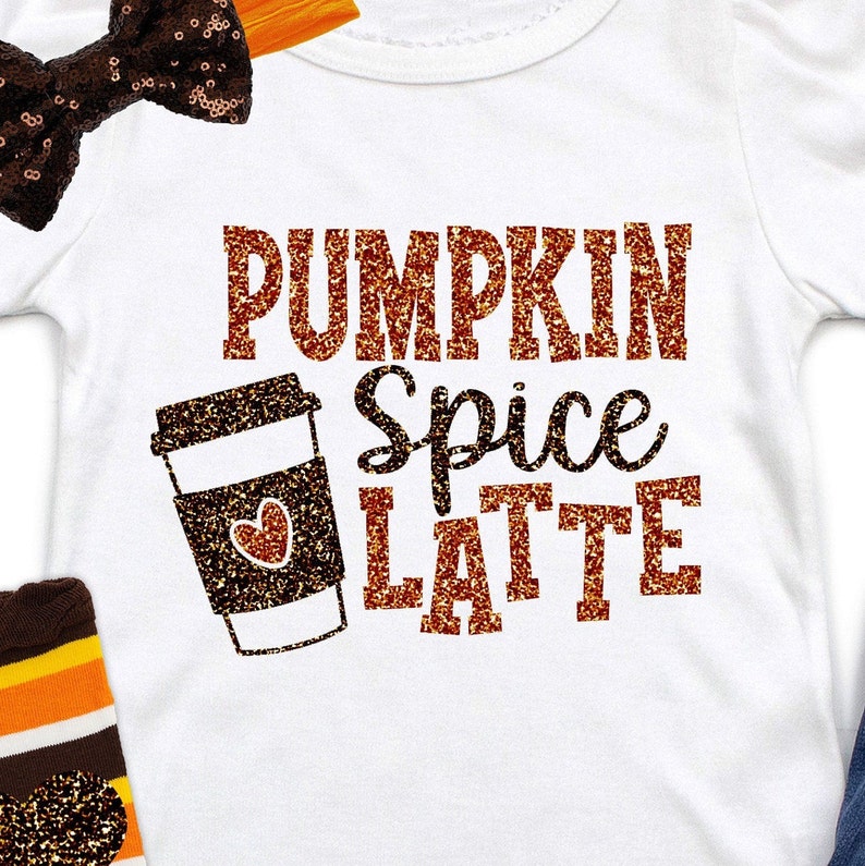 May include: White baby bodysuit with the text "PUMPKIN SPICE LATTE" in glittery orange and brown. A coffee cup graphic with a heart is also featured. A brown sequin bow and striped socks are in the image.