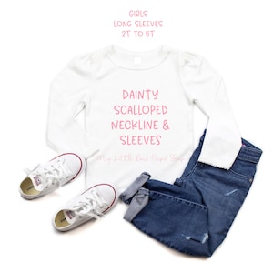 May include: White long-sleeve shirt with a pink graphic that says "DAINTY SCALLOPED NECKLINE & SLEEVES" and "My Little Bow Peeps Shop".