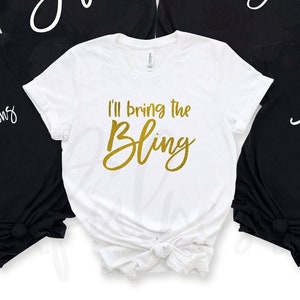 May include: White t-shirt with gold glitter text that reads "I'll bring the bling".