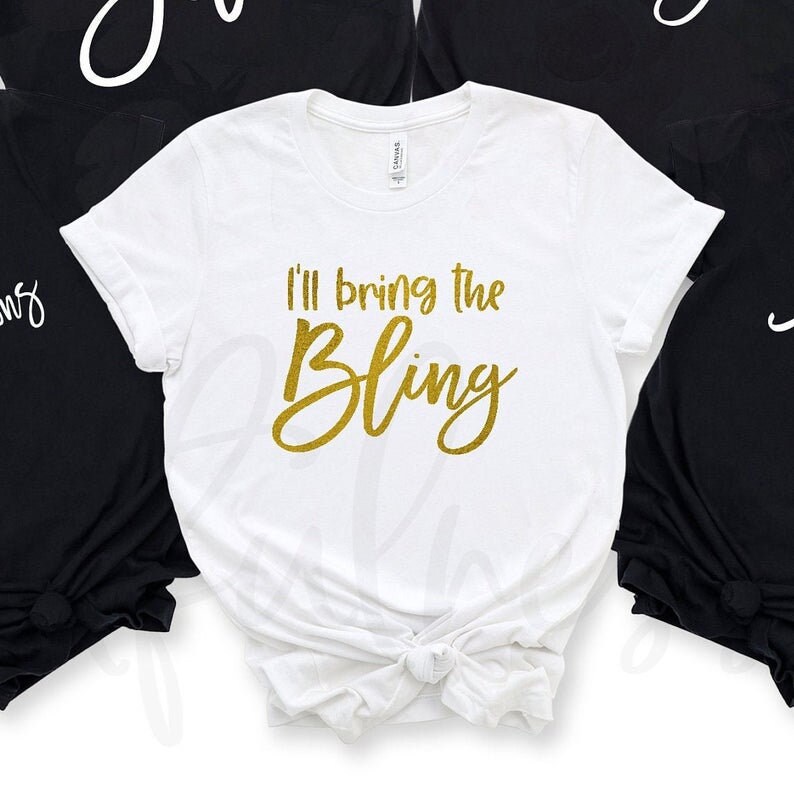 May include: White t-shirt with gold glitter text that reads "I'll bring the bling".