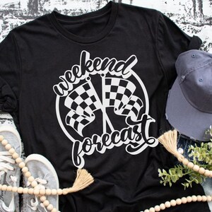 May include: Black t-shirt with a white graphic design of chequered flags and the text "weekend forecast".