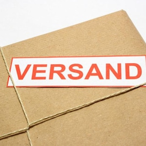 May include: A brown paper package tied with twine and labeled "VERSAND" in red letters.