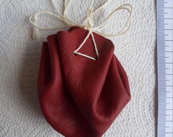 Leather bag round, bordeaux-red, with linen ribbons