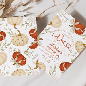 Fall-themed 1st birthday pumpkin digital invite with watercolor pumpkins, bows, and florals in blush, ivory, and burnt orange, displayed on a printed card and matching iPhone mockup.