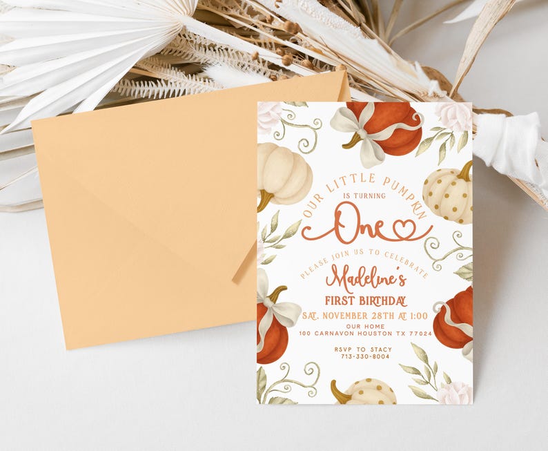 Fall-themed 1st birthday pumpkin digital invite with watercolor pumpkins, bows, and florals in blush, ivory, and burnt orange, displayed on a printed card and matching iPhone mockup.