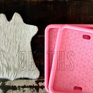 May include: Two pink silicone phone cases with a geometric pattern. The cases are stacked on top of each other.