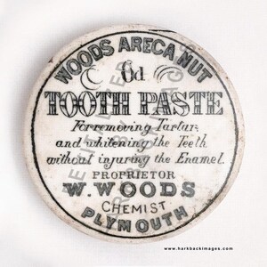 May include: Antique round container for Woods Areca Nut Tooth Paste. The white container has black text that reads "TOOTH PASTE" and "For removing Tartar and whitening the Teeth without injuring the Enamel." The container also has the text "W. WOODS CHEMIST PLYMOUTH."