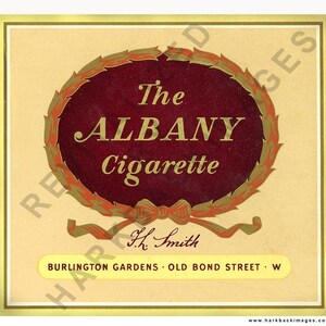 May include: Vintage advertisement for "The Albany Cigarette." The design features a burgundy oval with gold lettering and a decorative wreath. The text includes "Burlington Gardens, Old Bond Street, W."