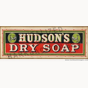 May include: Vintage advertisement for Hudson's Dry Soap. The rectangular sign features a red and black background with white text. The top and bottom borders have a decorative Greek key design. The sign includes illustrations of a hand holding a fork.