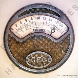 May include: Vintage round electrical meter with a metal frame and a textured, tan-colored center. The meter face displays numbers from 0 to 20, labeled "AMPERES." The bottom of the meter has the letters "GEC" in an oval. A classic industrial design.