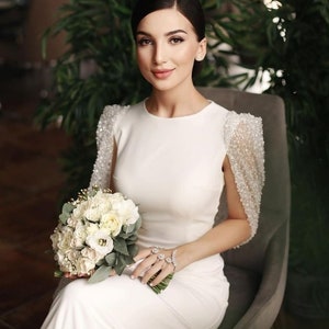 Modest minimalistic wedding dress with sparkled cape embellished with pearls and sequins ,crew neck