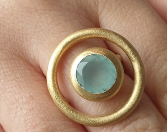 Unusual, round, gold plated ring with a chalcedony.